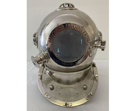 A large ornamental chrome coloured divers helmet with front opening hinged door and glass panels. Marked "Anchor Engineering,