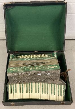 A vintage accordion by Casali, Verona, Italy. Green mother of pearl effect finish. Clear stone and floral decoration to top. 