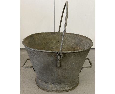 A vintage galvanised pail with carry handle and two side handles.  Approx. 31cm tall.