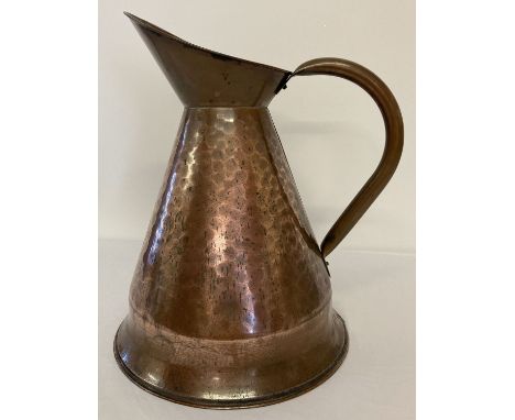 A large vintage copper jug with hammered effect detail.  Approx. 41cm tall.