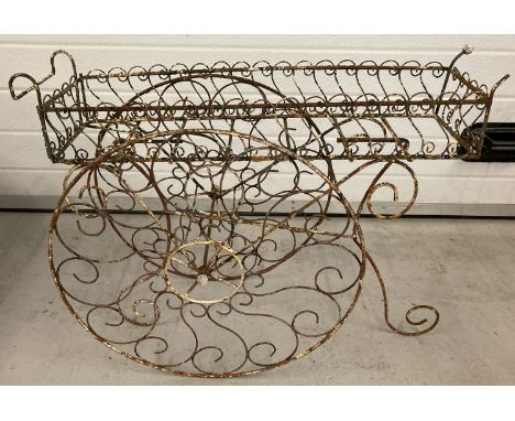 A vintage wirework plantstand in the shape of a decorative barrow.  Approx. 73cm x 58cm tall.
