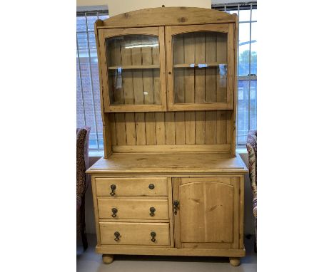 A vintage pine double dresser with glass fronted doors to top. 2 sectional dresser with cupboard and 3 drawers to base sectio