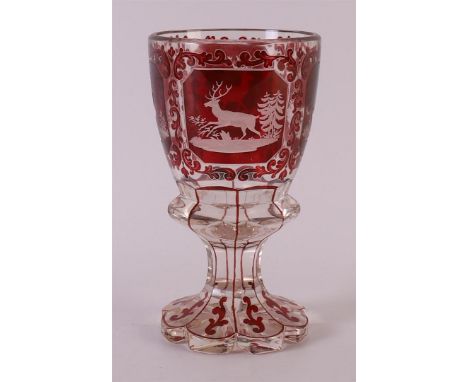 A clear and red glass glass, Bohemia, 2nd half of the 19th century. Cut decor of red deer in landscape and volutes, faceted t