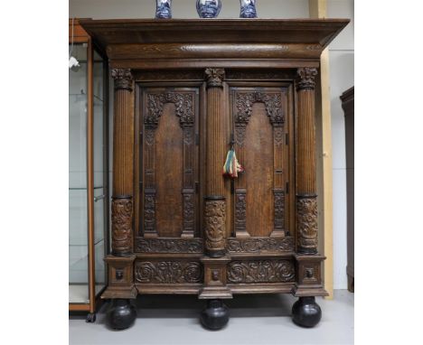 A two-door Keeftkast, Holland, Renaissance, Groningen 17th century. Profiled hood, panel doors with carved floral decor and f