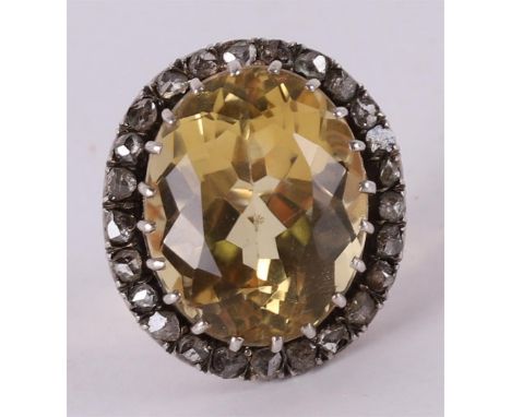 A 9 kt BWG ring with a facet cut burnt amethyst and an entourage of rose cut diamonds, 19th century. Ring size 16 mm.