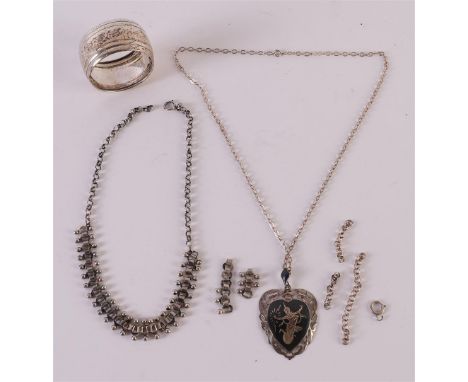 Two various silver necklaces and a napkin ring, totaling approximately 62 grams.