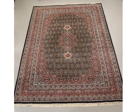 An Oriental wool carpet with blue background, Iran, Ind-Bidjar, l 355 x w 255 cm.