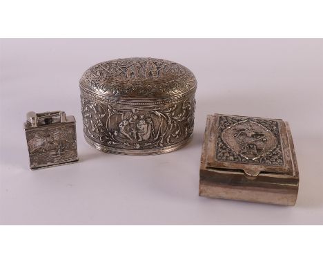 A second grade 835/1000 oval silver tea caddy with Old Dutch relief decor, year letter 1934. Includes Djocja silver cigarette