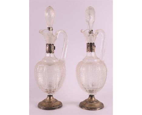 A pair of glass decanters with silver frames, around 1900, h 34 cm, to. 4x.