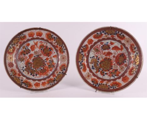 A pair of 'rouge de fer' porcelain plates, China, Qianlong 18th century. Polychrome decor of carp and flora on the shelf, the