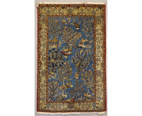 A Persian silk carpet, Ilam Sherkat Farsh. Polychrome decor of deer, hares and birds in floral surroundings on blue ground, m