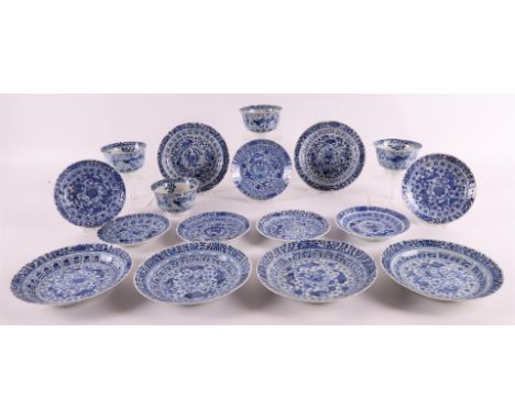 A series of four porcelain contoured cups and seven saucers, China, Kangxi style, 19th century. Blue underglaze decor of perc