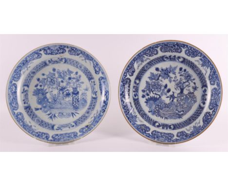 A pair of blue/white porcelain deep dishes, China, Qianlong, 18th century. Blue underglaze decor of valuables and flora on th