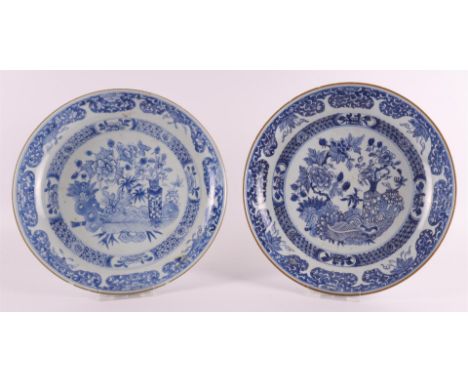 A pair of blue/white porcelain deep dishes, China, Qianlong, 18th century. Blue underglaze decor of valuables and flora on th