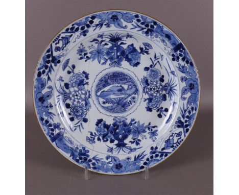 A blue and white porcelain dish with raised centre, China, Younzheng 18th century. Blue underglaze decoration of flora and na