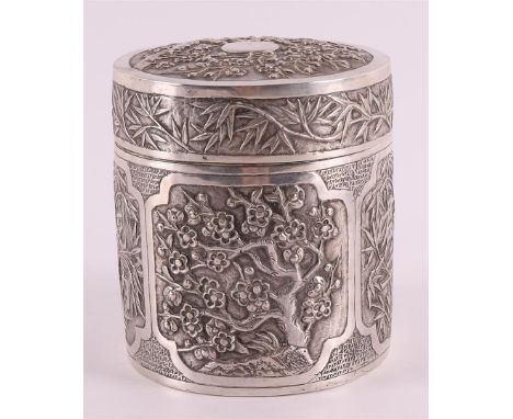 A silver cylindrical tea caddy, China, 1st half of the 20th century. Relief decor of prunus, bamboo and character signs, mark