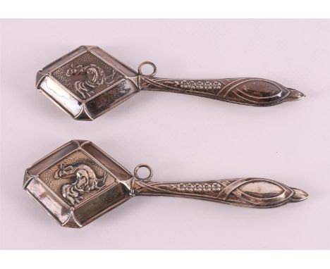 Two second grade 835/1000 silver rattles with decoration of roosters, 20th century, length 13.5 cm, to. 2x.