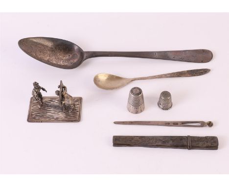 A lot of various silver, including a miniature of a man on a scaffold, needle case and spoon, total 95 grams, up to. 7x.