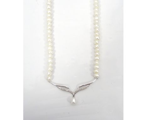 CULTURED PEARL AND DIAMOND NECKLETthe front nine carat gold pendant section set with diamonds and a pearl drop, on attached p