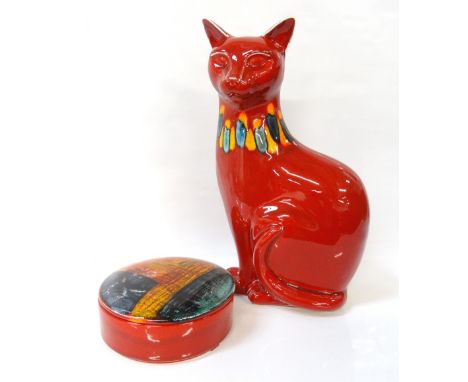 POOLE POTTERY CATseated with a red body glaze and blue and yellow collar, 29.5cm high; together with a Poole pottery circular