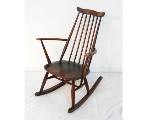 ERCOL ROCKING CHAIRwith a shaped top rail above a stick back and shaped arms, and solid seat  