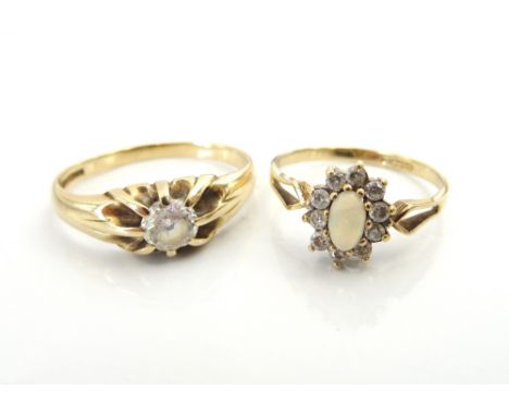 TWO GEM SET GOLD RINGSone an opal and clear gem set cluster ring in unmarked gold, size L-M; the other a clear gem set solita