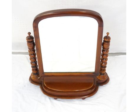 VICTORIAN MAHOGANY ADJUSTABLE DRESSING MIRRORheld on bobbin turned supports, the shaped base with lidded compartment, raised 