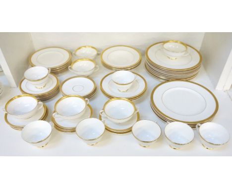 ROYAL DOULTON 'ROYAL GOLD' TEA/DINNER SERVICEcomprising seven cups; ten saucers; eight side plates; sixteen dinner plates; si
