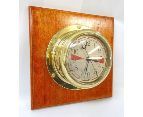 VINTAGE SHIPS RADIO ROOM CLOCKin brass case, mounted on wooden plinth