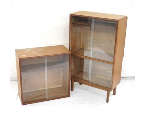 'BEAVER AND TAPLEY LTD.' TEAK GLAZED CABINETwith two pairs of sliding doors, with an adjustable shelf, standing on tapering s