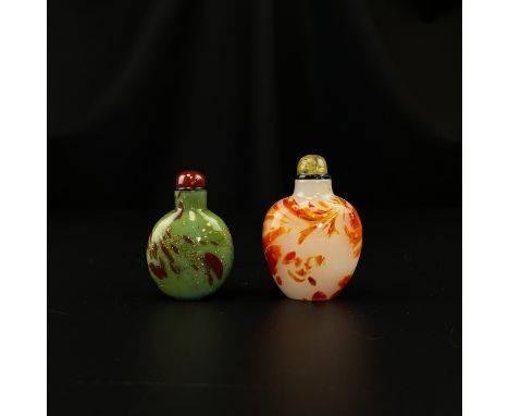 Two 19th century Chinese Qing dynasty snuff bottles to include one of baluster form with flecks of gold over a jade green gro