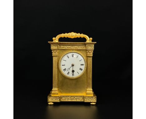 A large 20th century gilt metal carriage clock having a moulded handle over a breakfront cornice above the enamelled dial bea
