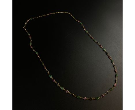 A gold plated necklace inset with jade cabochons and other stones.