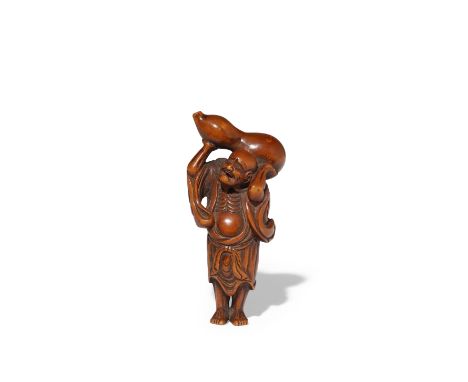 A JAPANESE WOOD NETSUKE OF CHOKARO SENNIN EDO PERIOD, 18TH CENTURY The Immortal grimacing with exertion as he lifts a large d