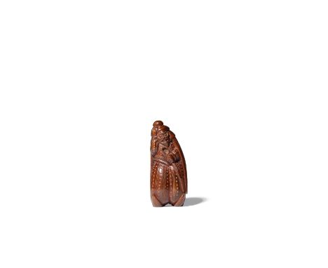 A LARGE JAPANESE WOOD NETSUKE OF A PORTUGUESE MERCHANT SHOWA OR LATER, 20TH CENTURY Depicted standing, holding a curved sword