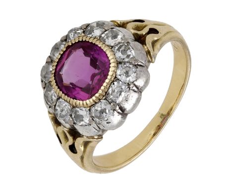 A late 19th century ruby and diamond cluster ring, the mixed-cut ruby bezel-set within a surround of old cushion-cut diamonds