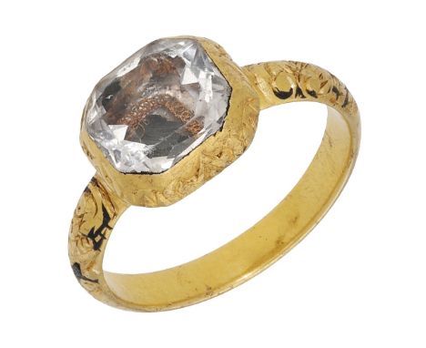 A rock crystal memorial ring, 17th century, the bezel comprising an octagonal faceted rock crystal over gold wire detail, wit