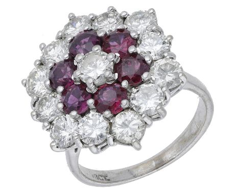 A ruby and diamond cluster ring, set throughout with circular-cut rubies and brilliant-cut diamonds, stamped ‘18CT’, total di