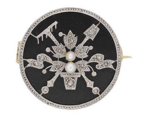 An early 20th century onyx and diamond brooch, the circular plaque with applied decoration of gardening theme, depicting a po