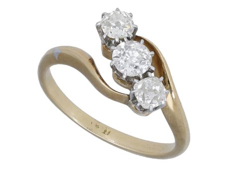 An early 20th century diamond three stone ring, of crossover design, set with three graduated old-cut diamonds, mounted in pl