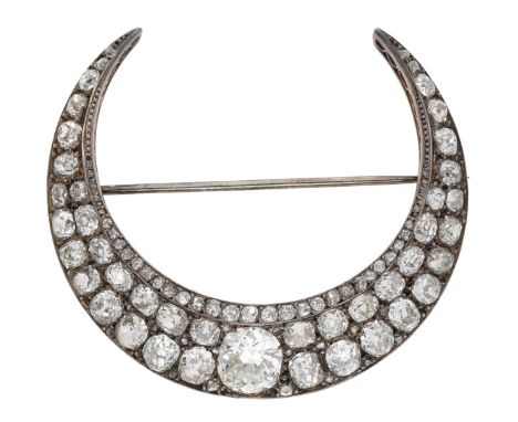 A late 19th century diamond crescent brooch, set throughout with graduated old brilliant, cushion and rose-cut diamonds, moun