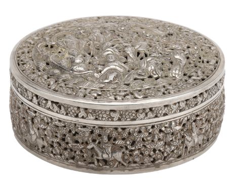 A South Asian silver circular box and cover, the cover ornately pierce-decorated with Immortals and other figures and phoenix