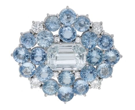 An aquamarine and diamond brooch, the lozenge-shaped cluster set with a central step-cut aquamarine within a surround of circ