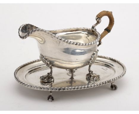 An Edward VII silver sauce boat on matching stand, in mid 18th century style, of good gauge, the boat with gadrooned rim, on 