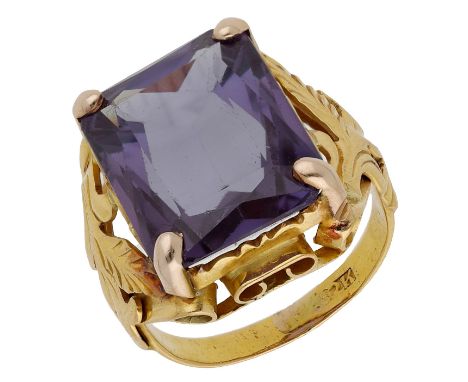 A dress ring, the cut-cornered synthetic colour change corundum in a foliate mount, indistinct stamp, ring size J.  £150-£200