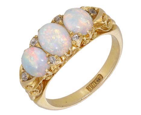 A late 19th century opal three stone ring, the graduated opal cabochons with old-cut diamond highlights, to a pierced scrollw