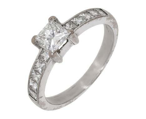 A diamond ring, the princess-cut diamond, weighing 0.61 carat, between shoulders set with similarly-cut diamonds, mounted in 
