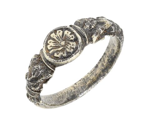 A post-medieval silver gilt ring, late 16th / early 17th century, the raised circular bezel bearing a rosette motif, between 