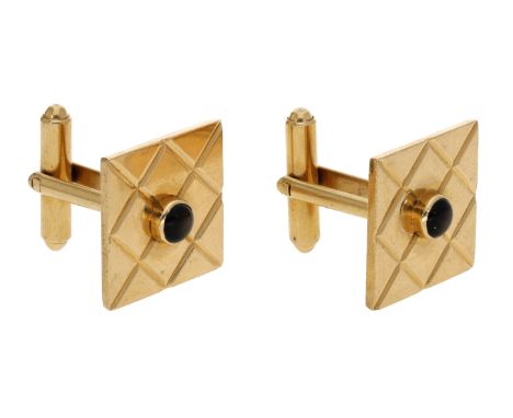 A pair of cufflinks, the square plaques with engraved latticework and a circular brown star sapphire cabochon to the centre, 
