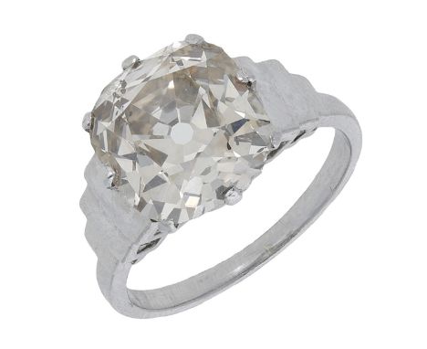 A diamond single stone ring, the old cushion-cut diamond of light brown tint, weighing 4.67 carats, between stepped shoulders